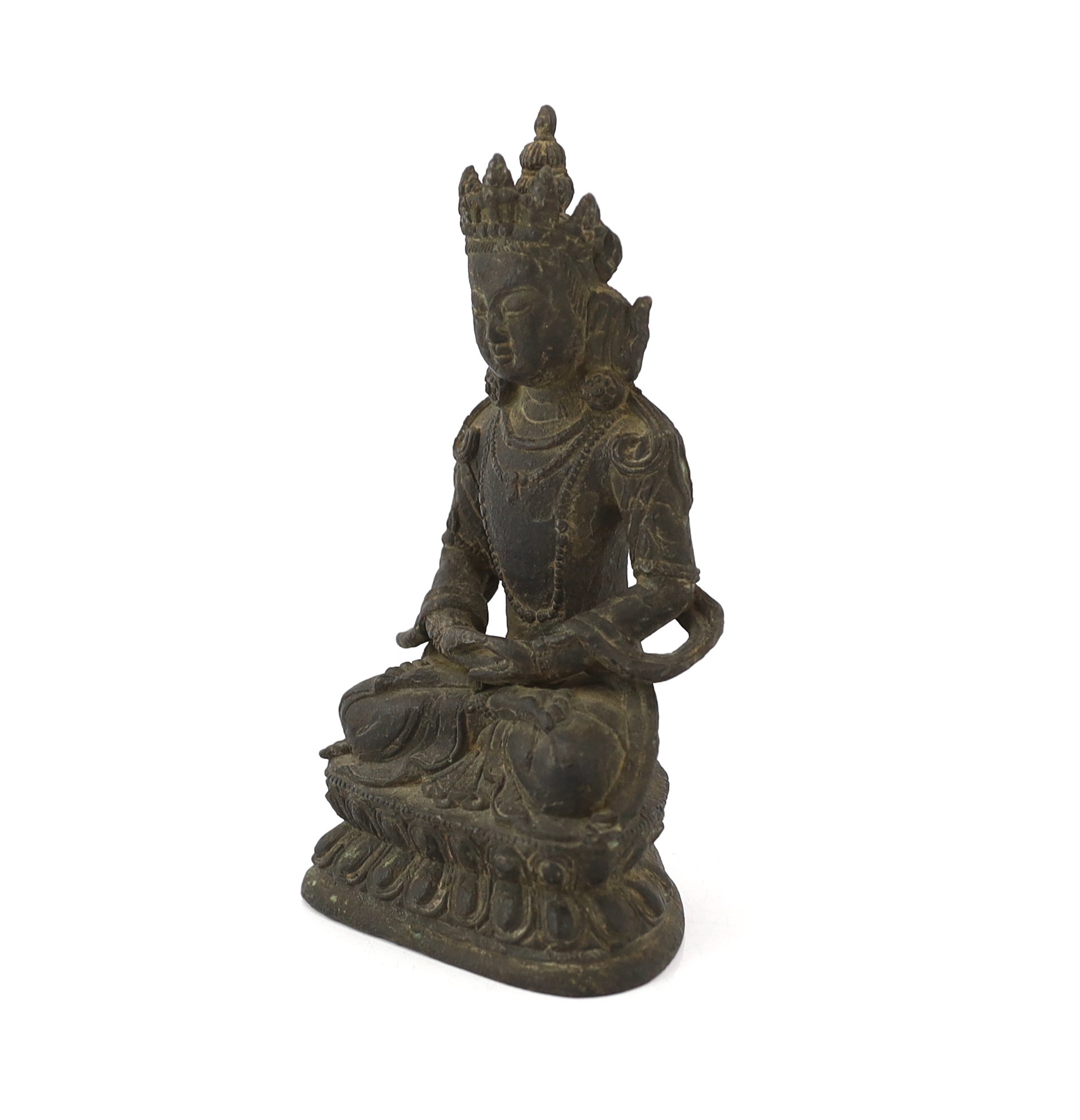 A Chinese bronze seated figure of Amitayus, probably 18th century, surface pitted